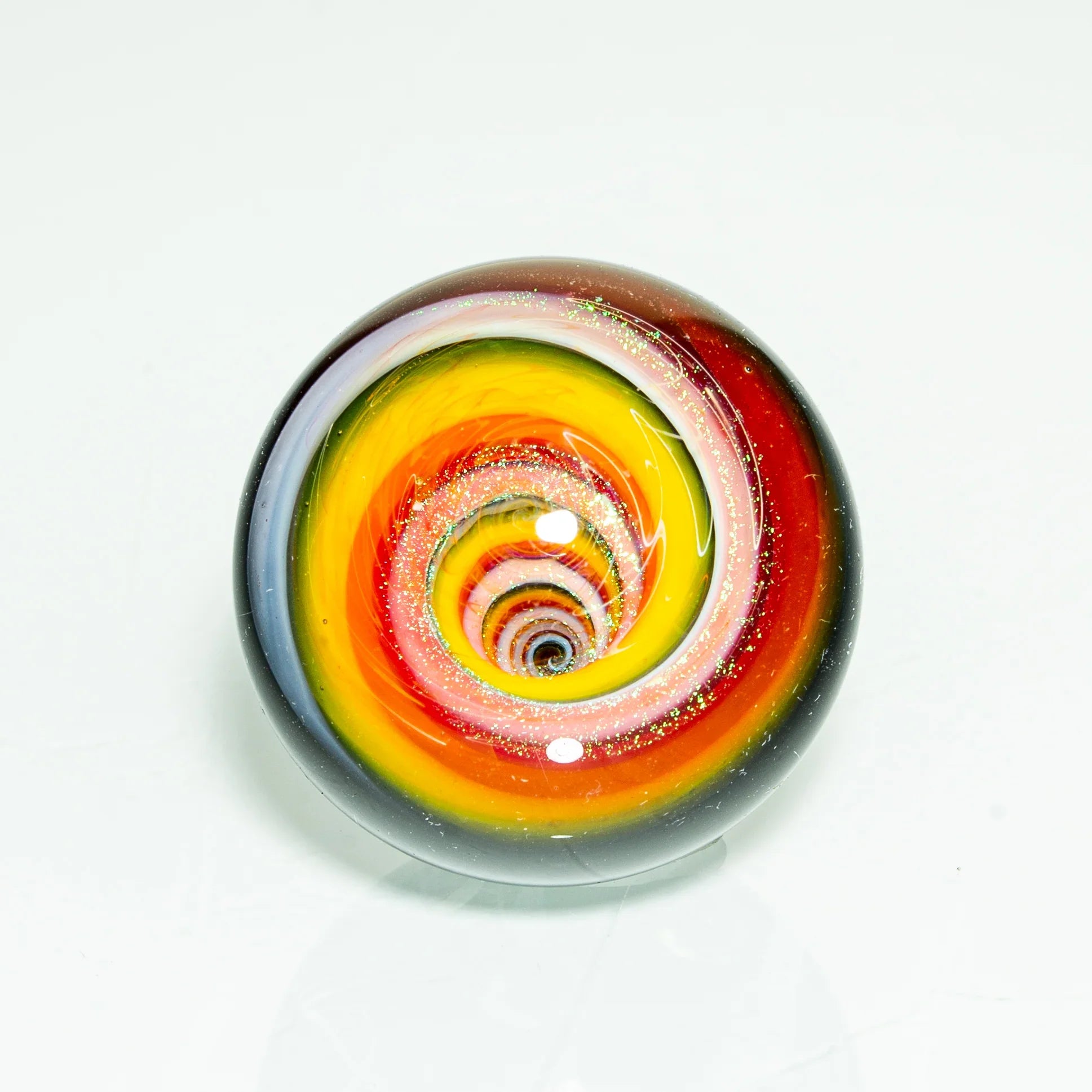 Hand-blown glass marble with vibrant rainbow dichroic vortex design, heady glass art