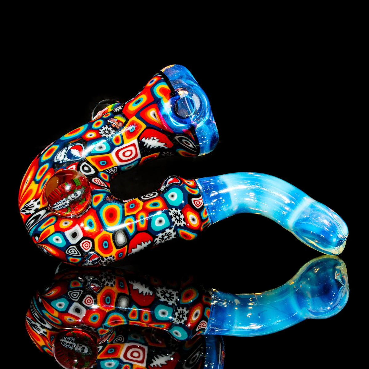 Colorful heady glass pipe with intricate patterns on a black reflective background