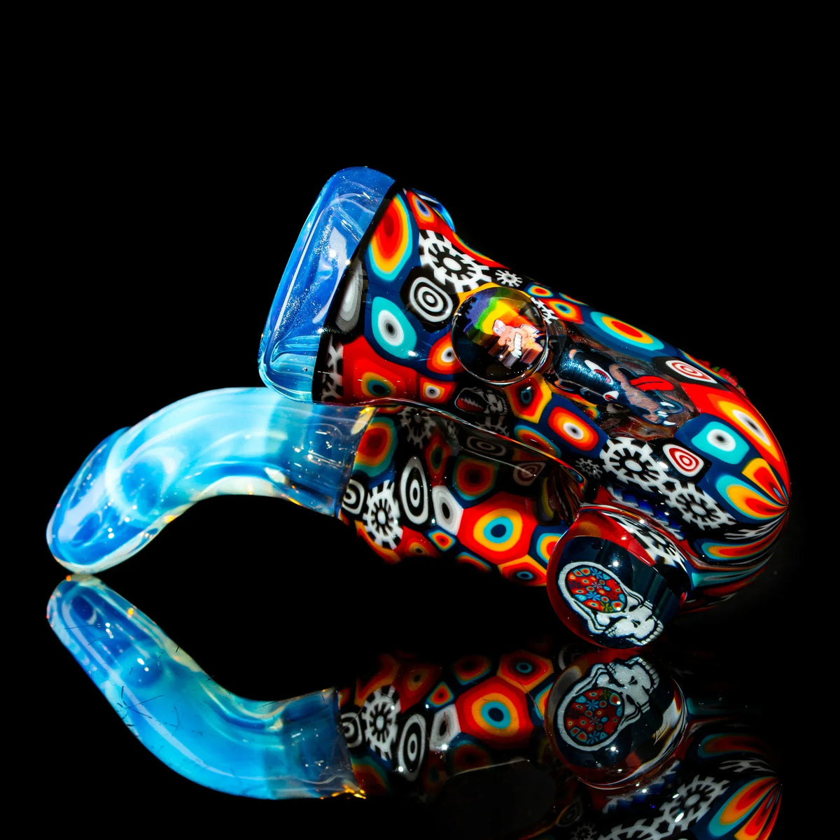 Colorful heady glass hand pipe with intricate patterns and vibrant blue mouthpiece on black background