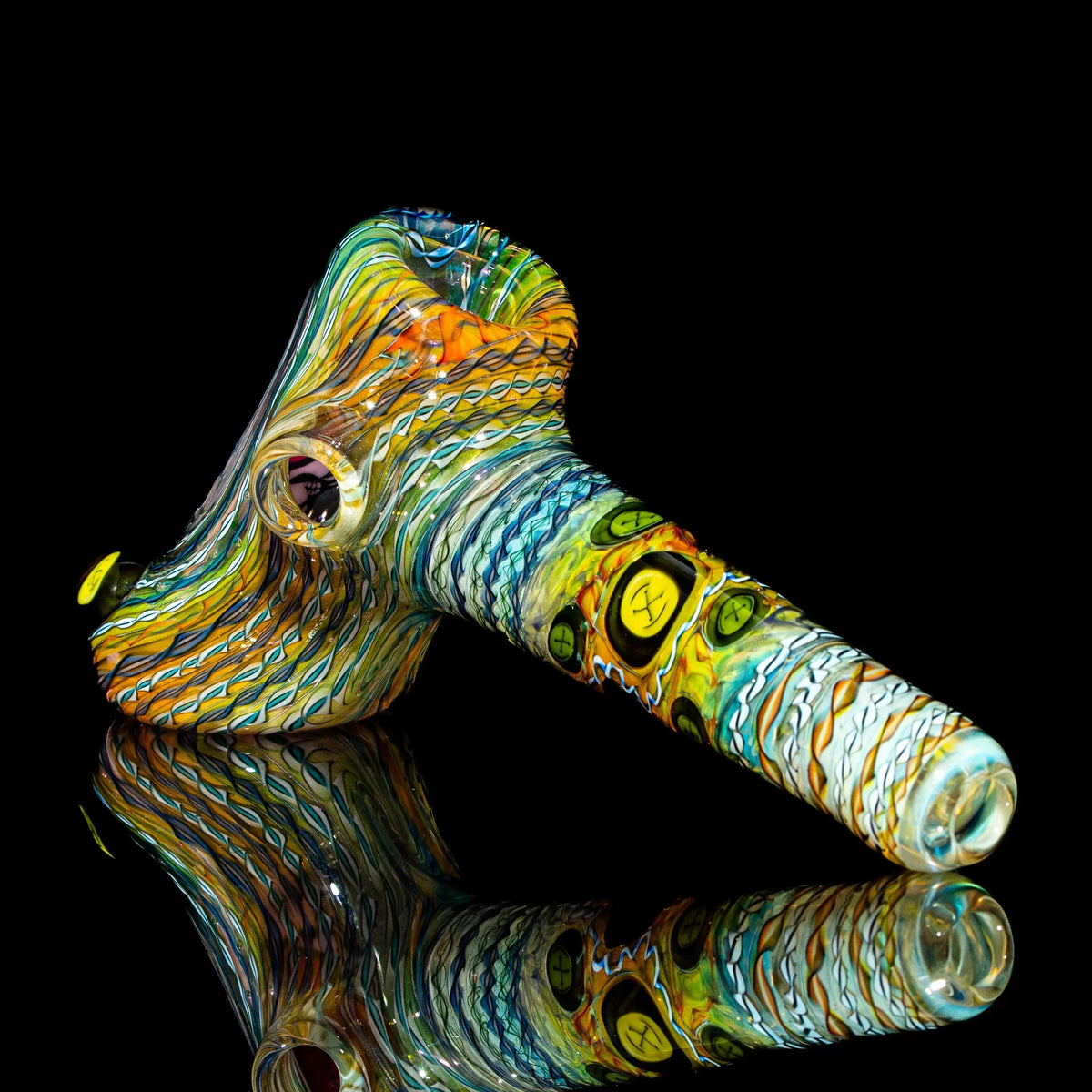 Hand-blown heady glass pipe with vibrant, swirling colors and intricate patterns on black background