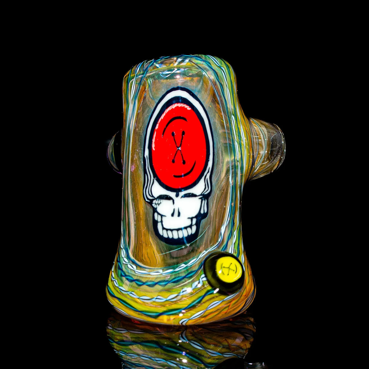 Heady glass pipe with colorful swirls and skull design on black background