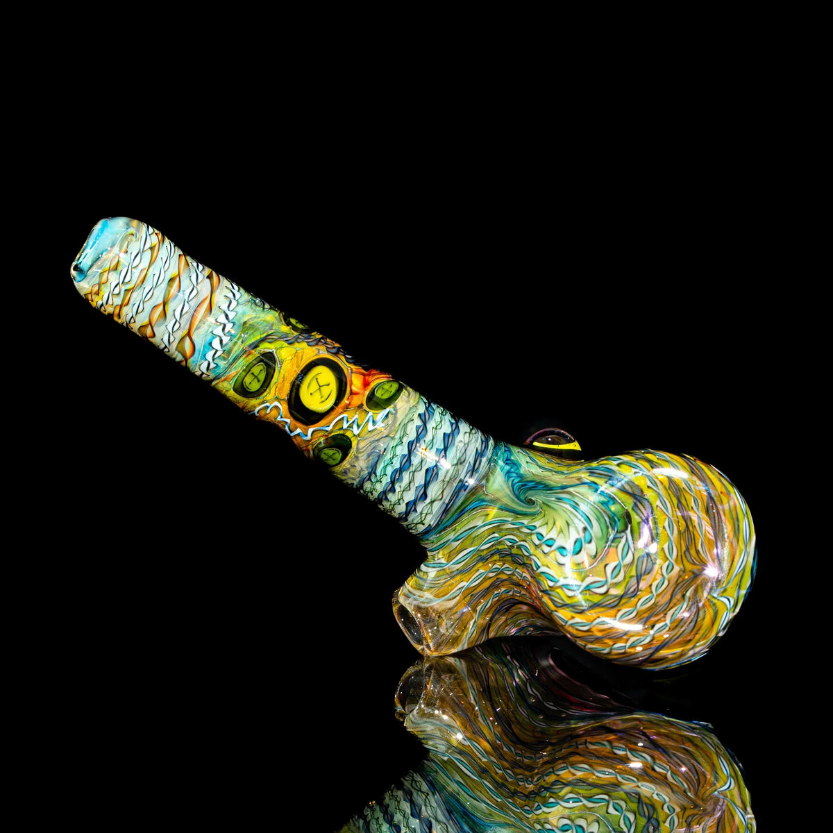 Hand-blown glass pipe with vibrant swirling patterns on black background