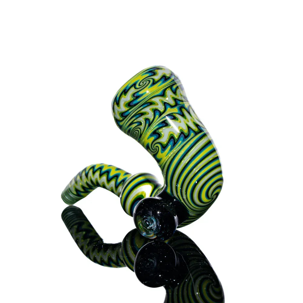 Hand-blown glass sherlock pipe with green, yellow, and black linework on reflective surface.
