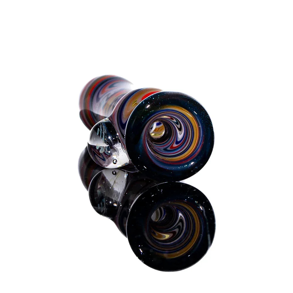 Handcrafted glass chillum with purple, red, black, and blue linework on a reflective surface
