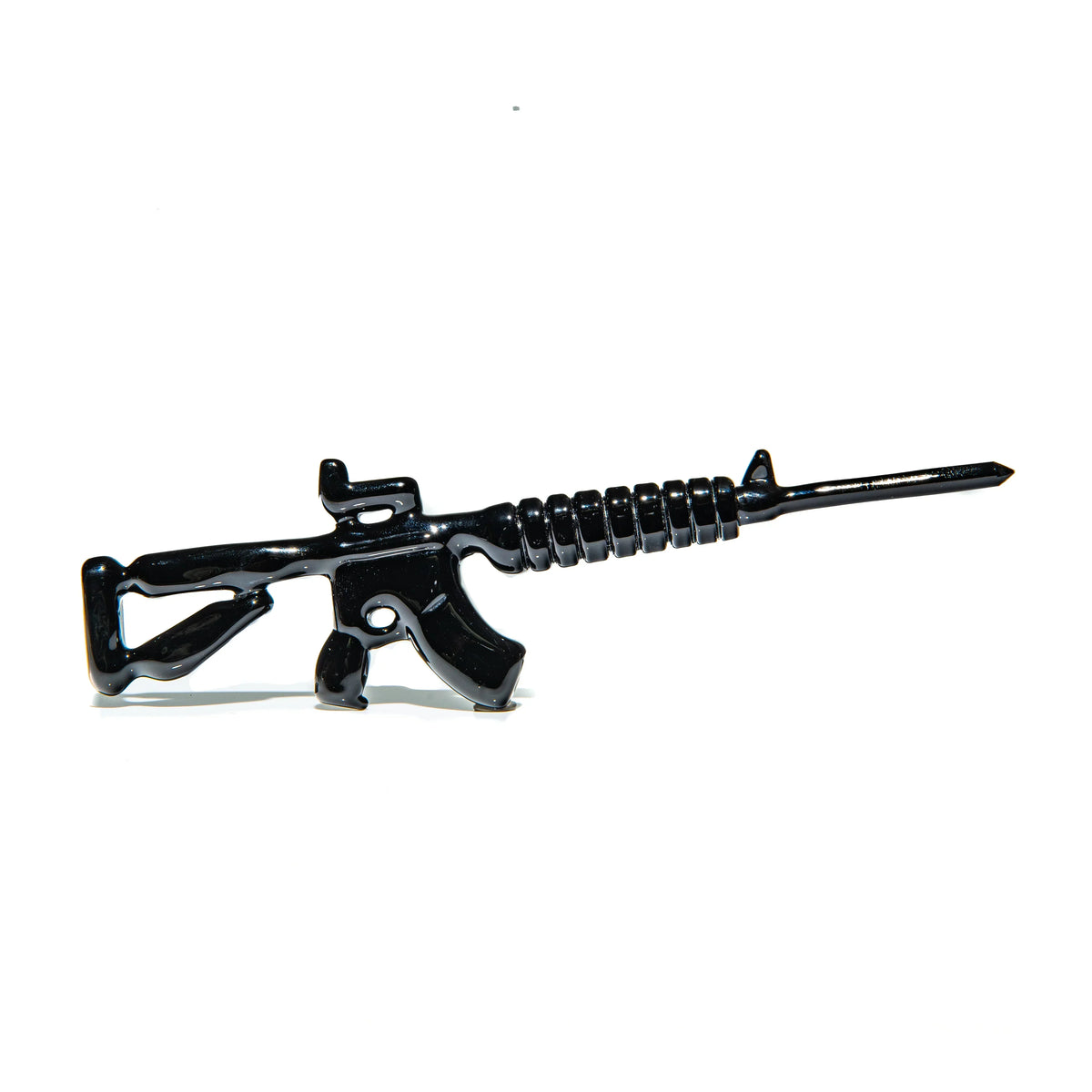 Black glass dabber tool shaped like a rifle, displayed on white background