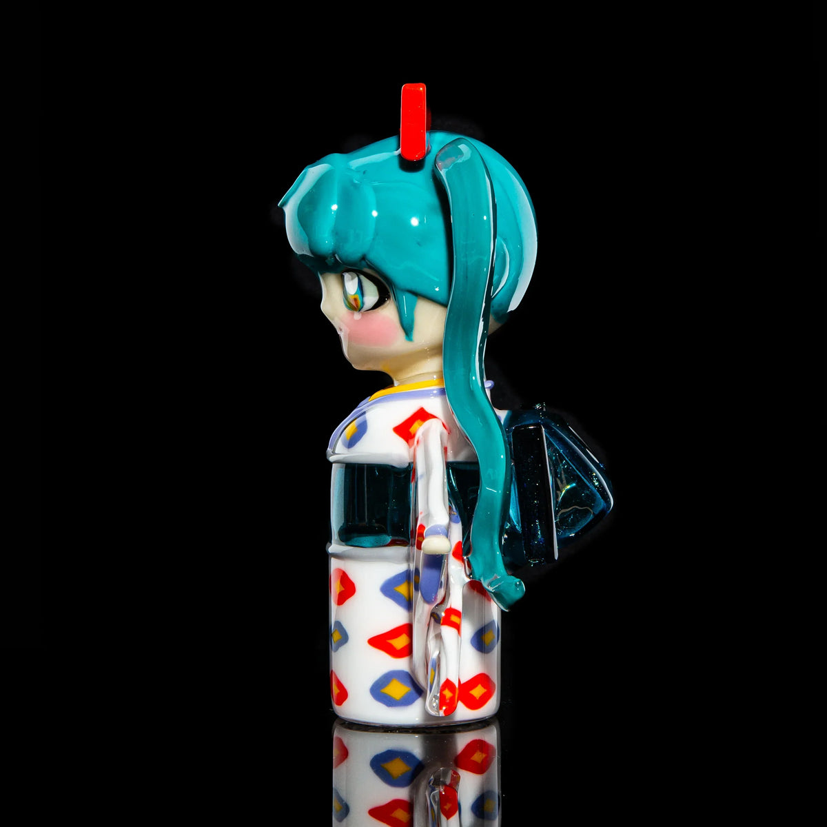 Handcrafted glass pipe shaped like an anime character with teal hair and colorful patterns