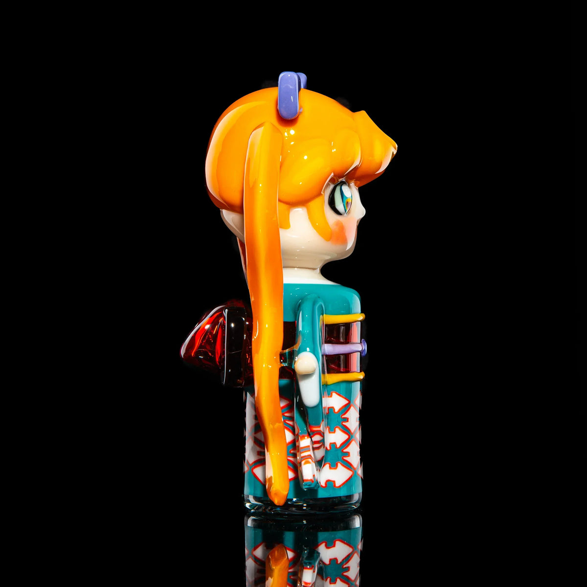 Hand-blown glass art pipe shaped like an anime girl with orange hair and colorful details