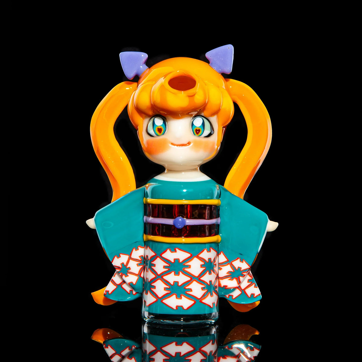 Colorful anime-inspired heady glass pipe with kimono design and orange pigtails on black