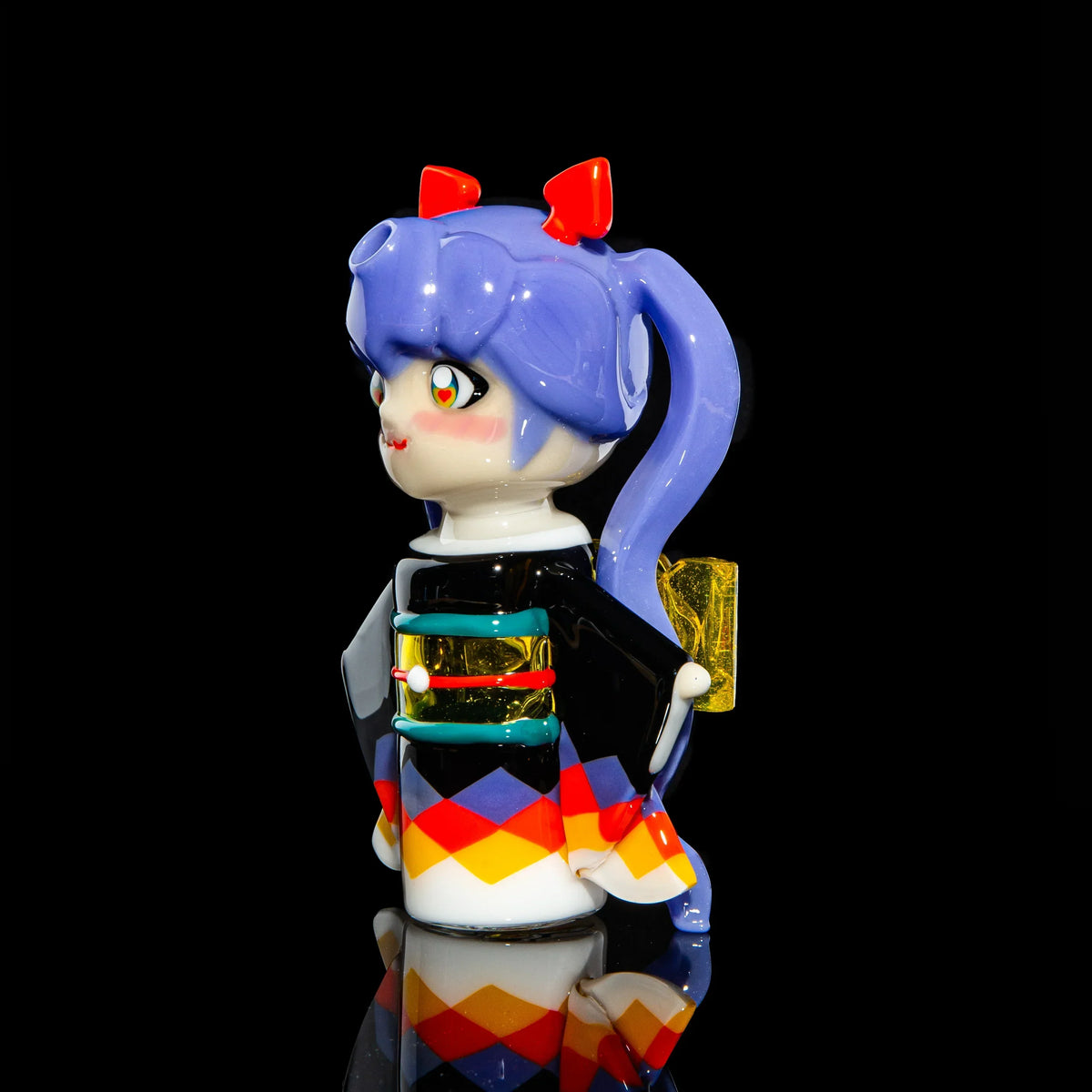 Colorful glass figure with purple hair, red bows, and patterned kimono on black background