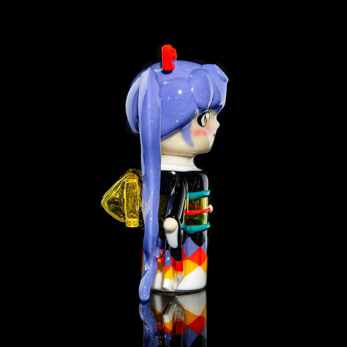 Handcrafted glass art figure with blue hair, colorful kimono details, and yellow accents