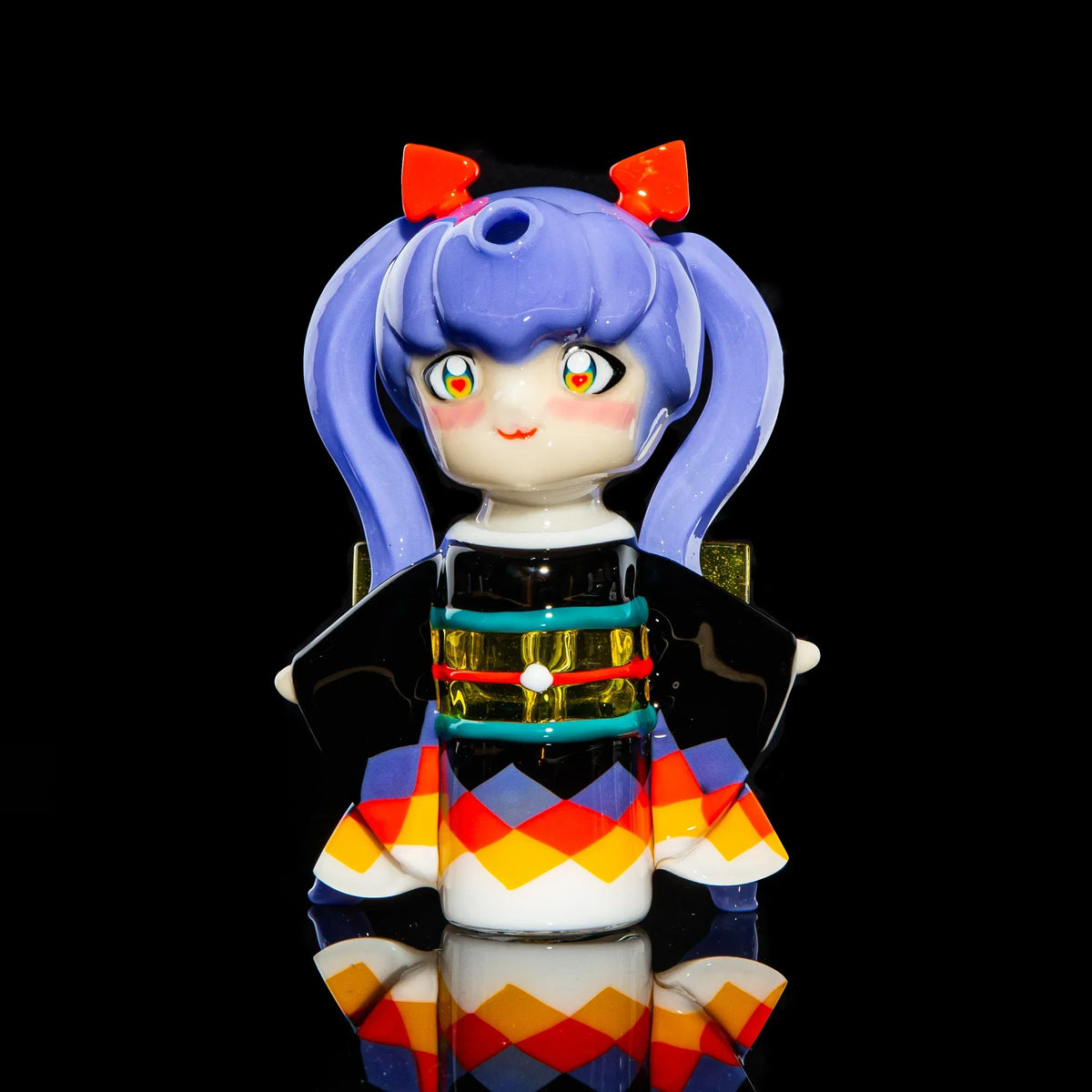 Hand blown glass figure with purple pigtails, colorful kimono, and red bows, black background