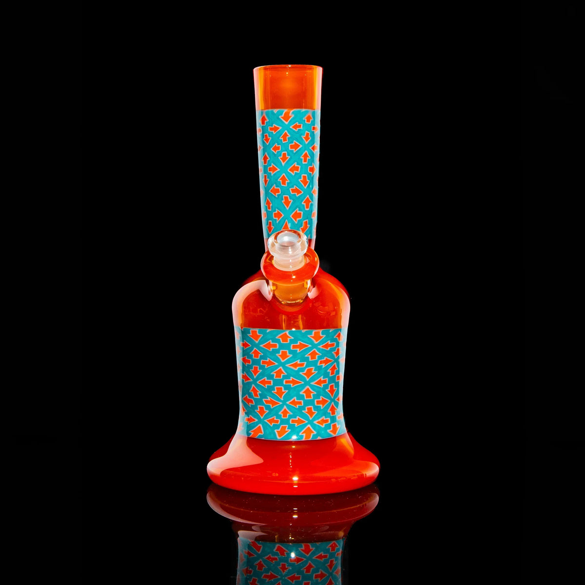 Red and orange glass water pipe with blue geometric pattern on black background