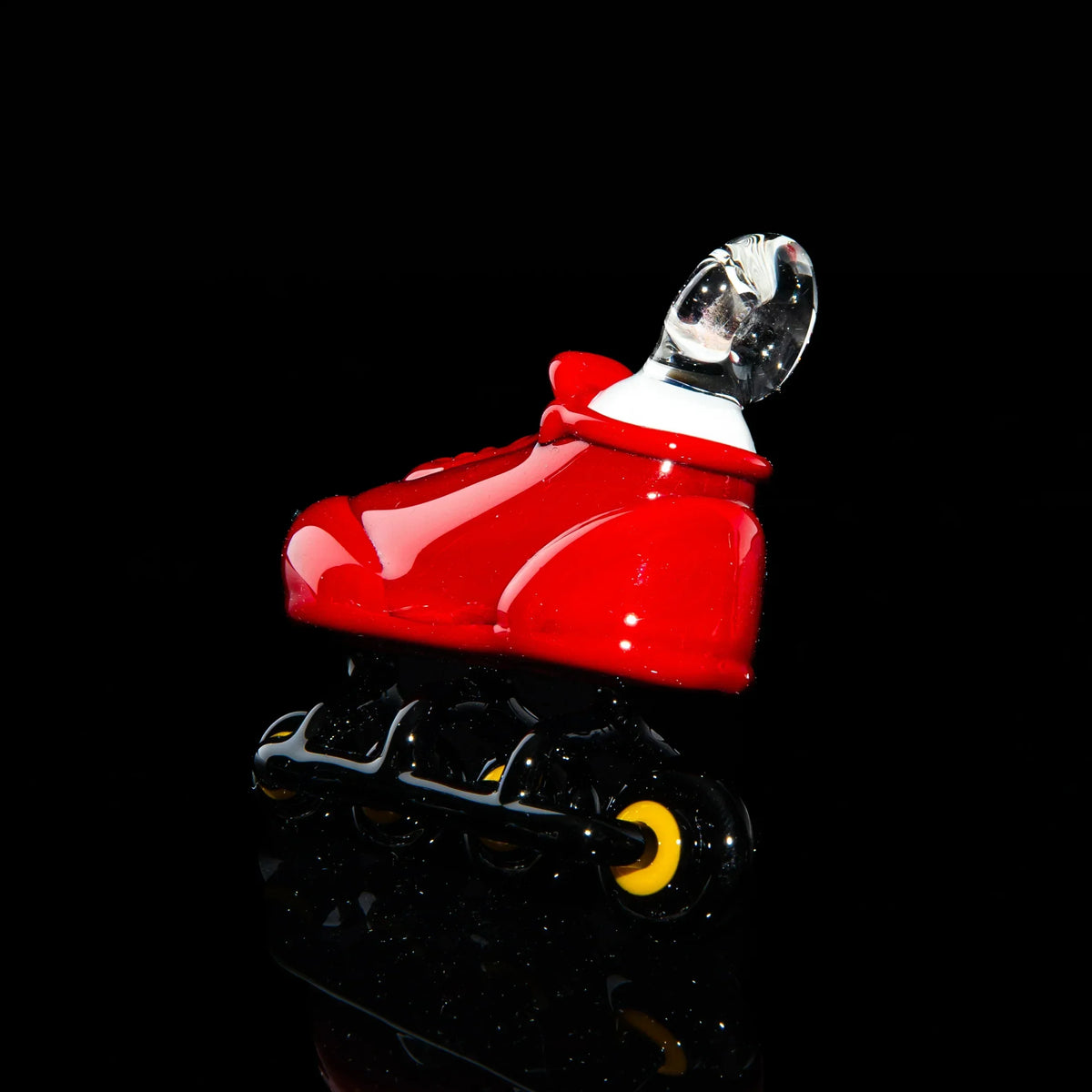 Red glass rollerblade pipe with black and yellow wheels on black background