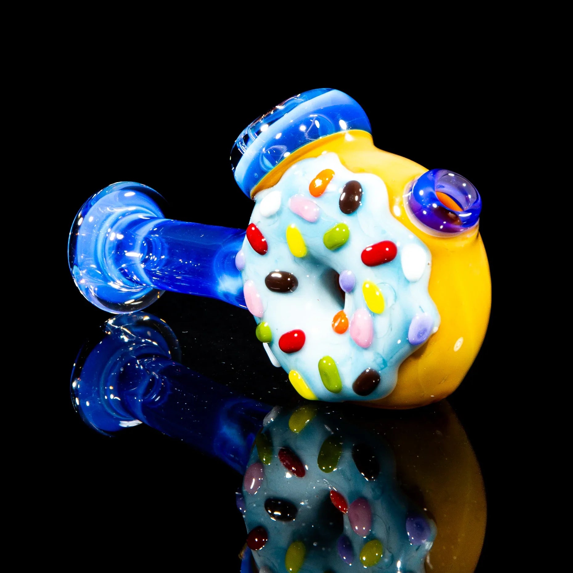 Colorful glass hammer pipe with blue stem and donut design with rainbow sprinkles