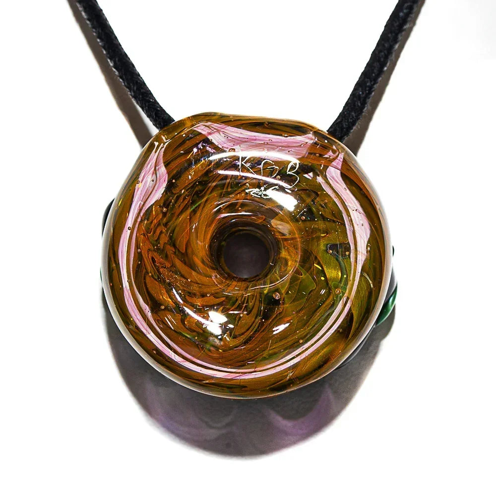 Handblown glass donut pendant with brown, pink, and metallic swirls on a black cord