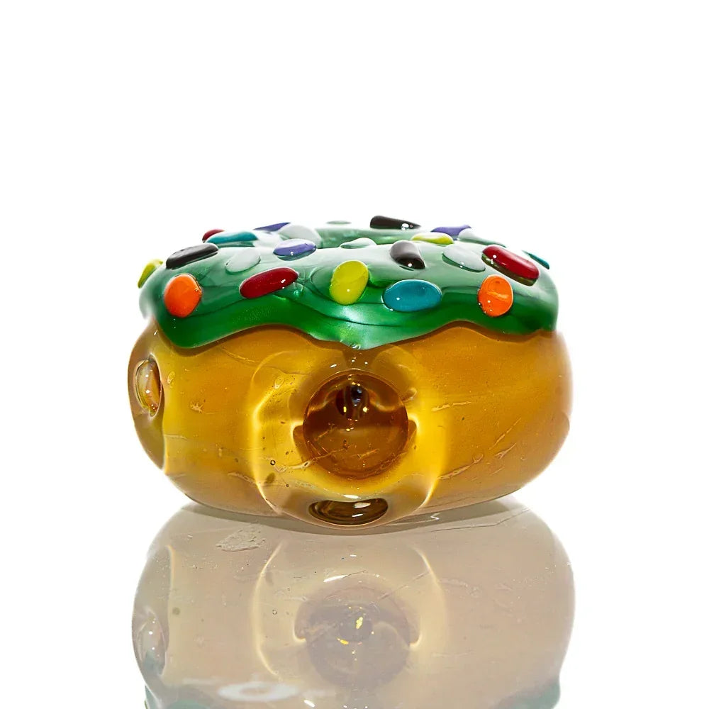 Glass donut-shaped dry pipe with frosted finish, green frosting, and colorful sprinkles