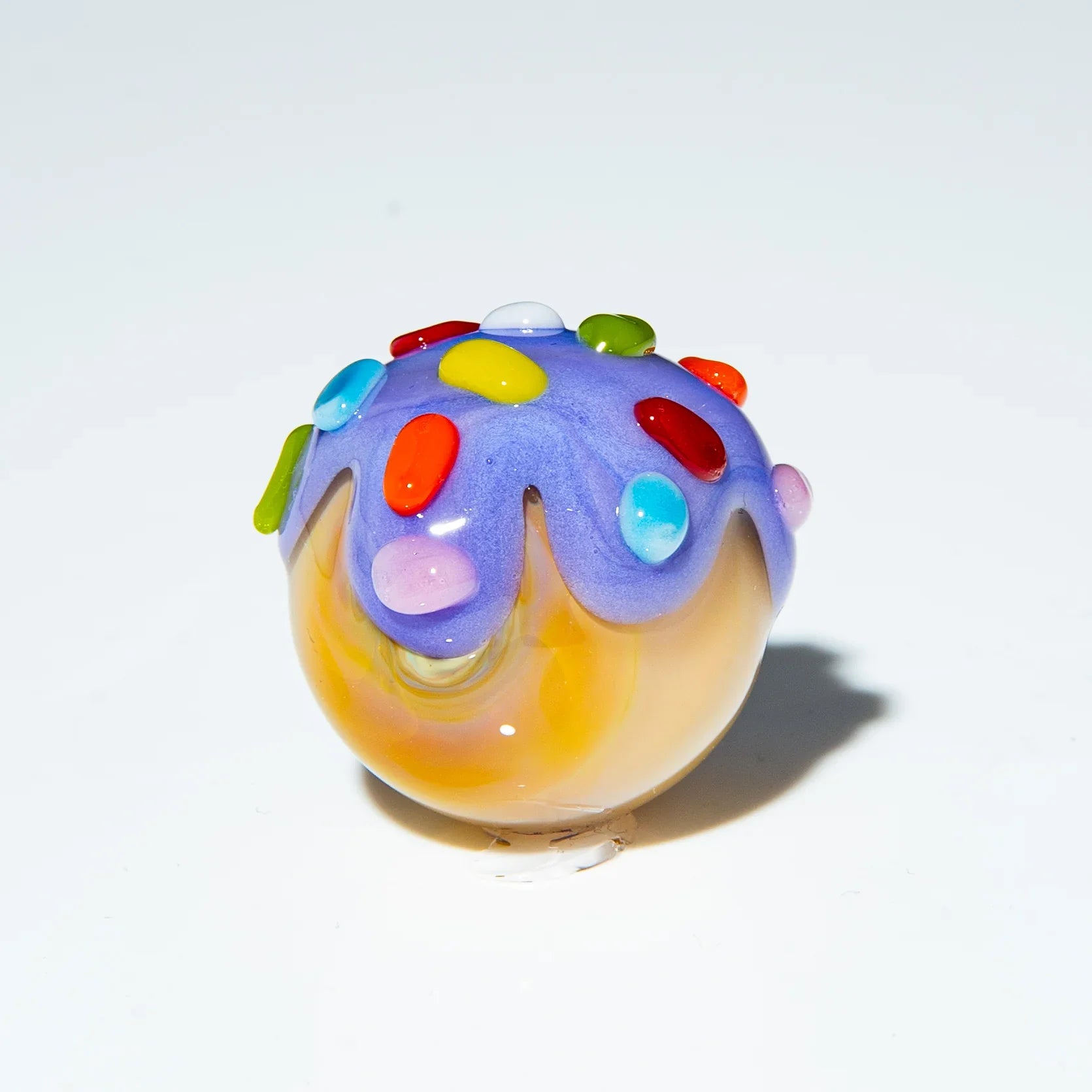Handcrafted glass marble with lavender top and colorful rainbow sprinkles design