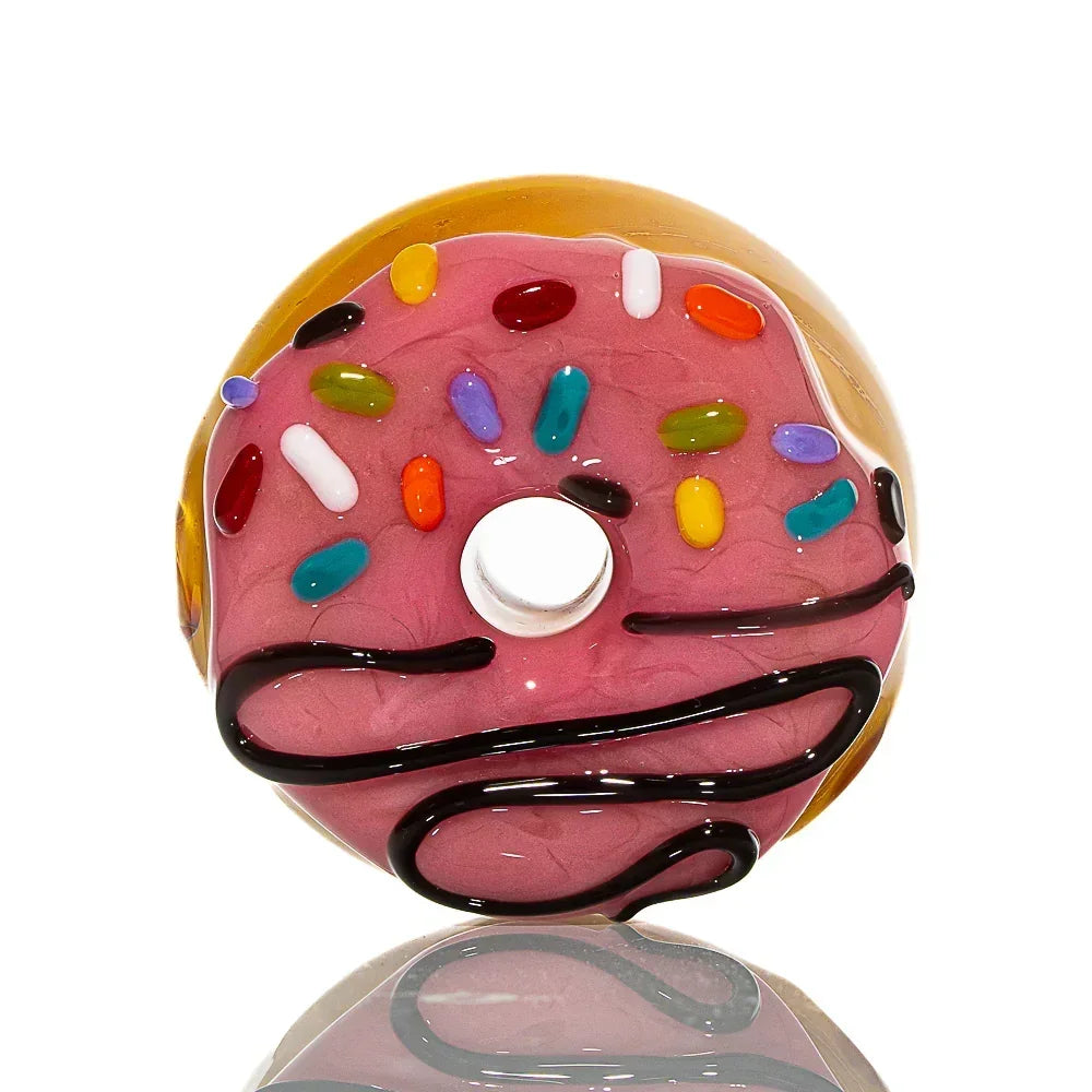Glass donut-shaped dry pipe with pink frosting, colorful sprinkles, and chocolate drizzle.