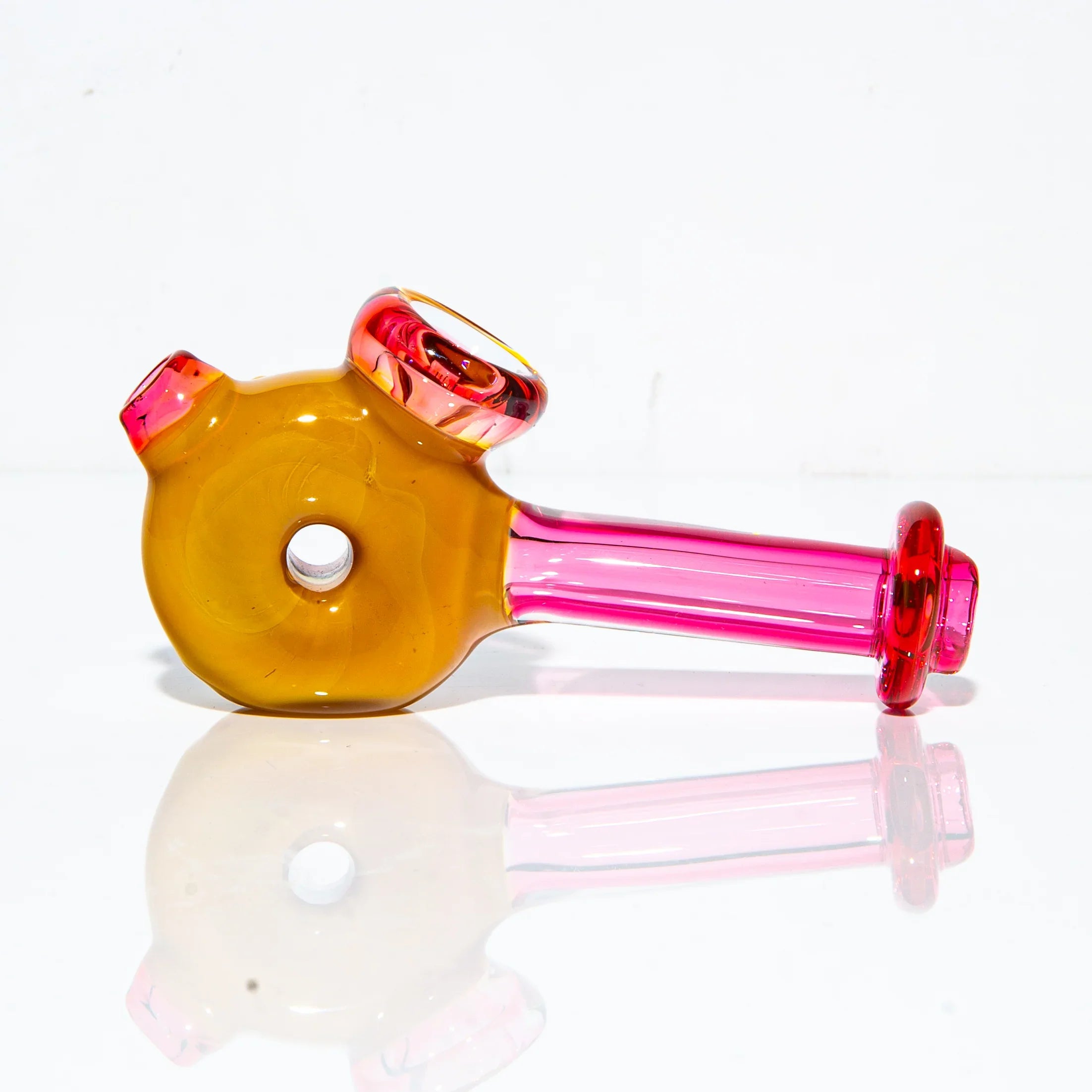 Hand-blown glass hammer pipe with strawberry and rainbow colors on white background