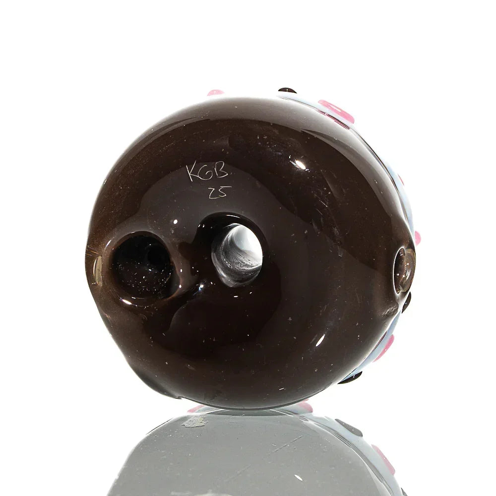 Chocolate donut-shaped glass dry pipe with pink sprinkles and vanilla frosted details