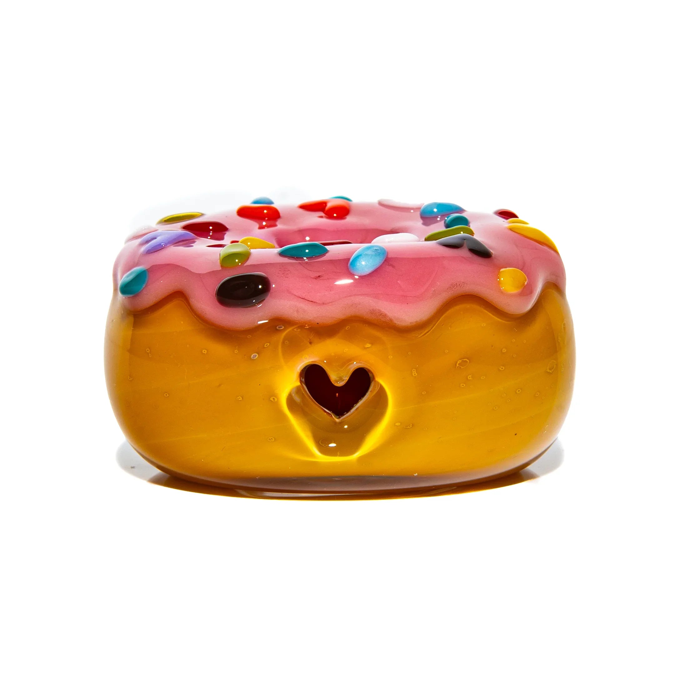 Hand-blown glass donut pipe with pink icing, rainbow sprinkles, and a heart-shaped carb hole.