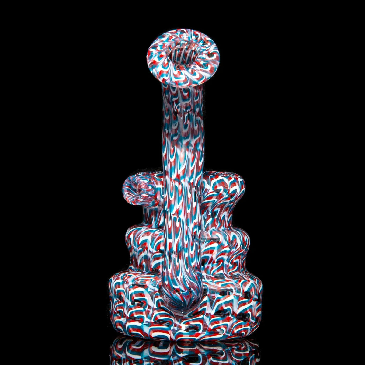 Colorful heady glass water pipe with intricate red, white, and blue swirling patterns