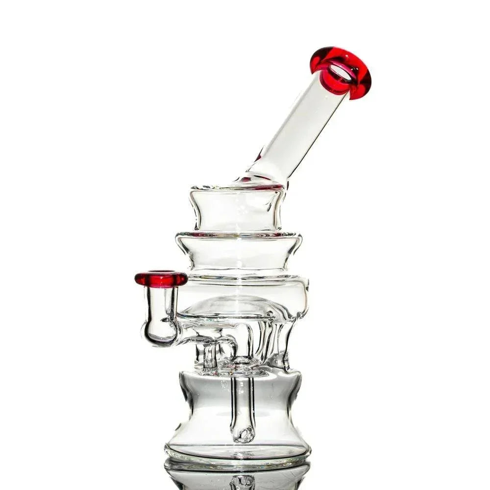 Clear glass water pipe with ruby red accents and unique tiered design on white background