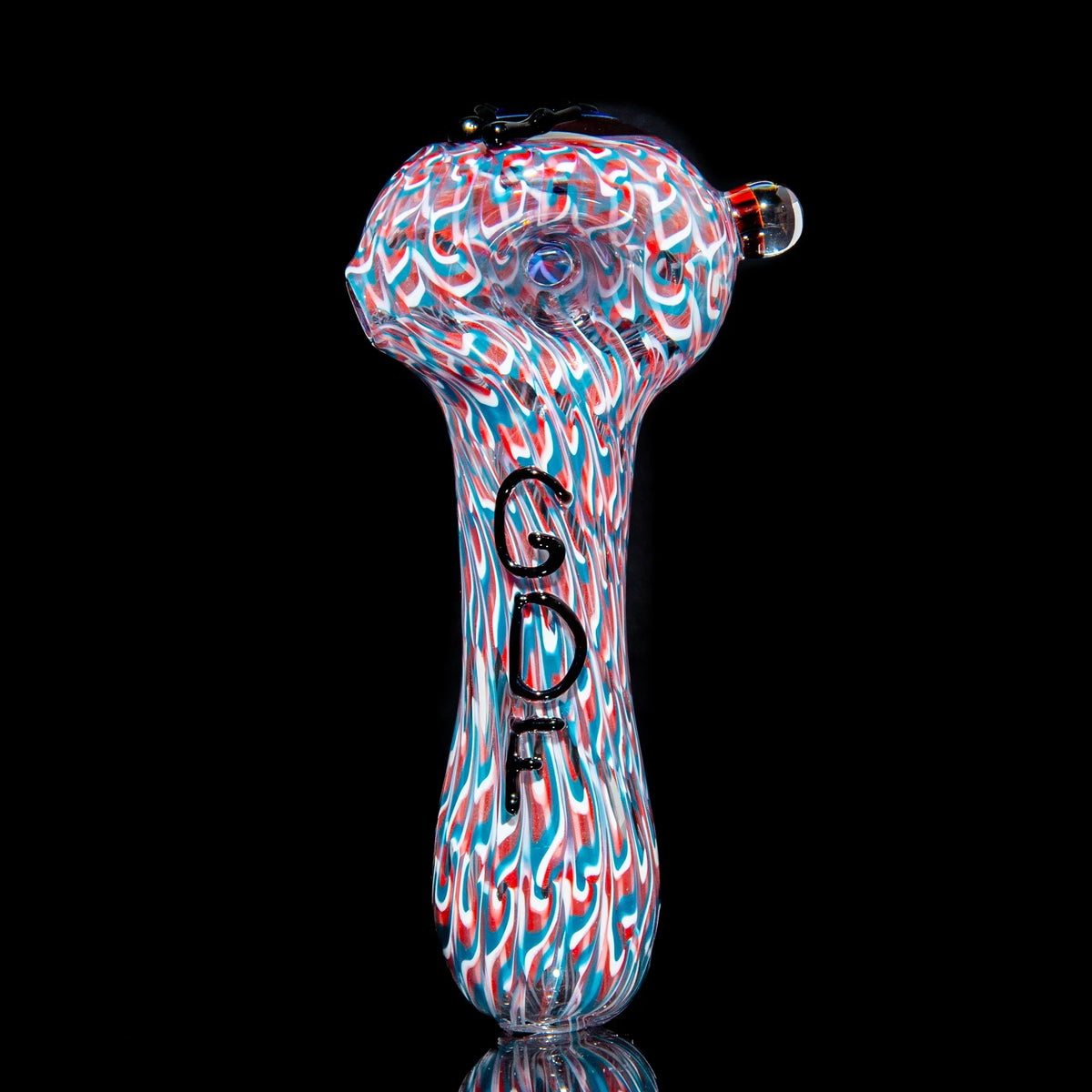 Colorful glass hand pipe with red, blue, and white swirl pattern on black background