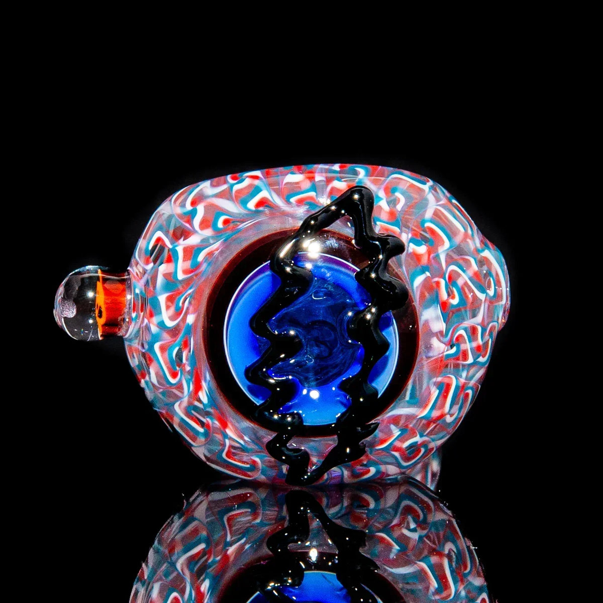 Colorful glass hand pipe with blue bowl and zigzag accent on black background
