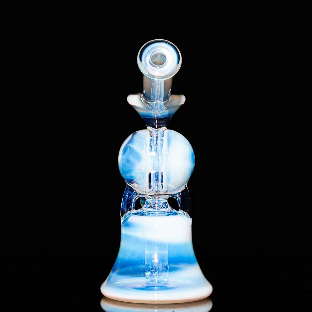 Blue and white glass recycler water pipe with split window design on black background