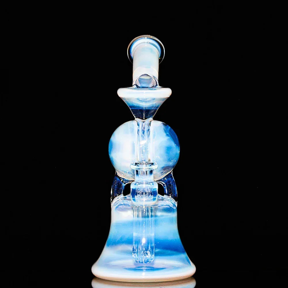 Blue and white glass recycler water pipe with split window design on black background
