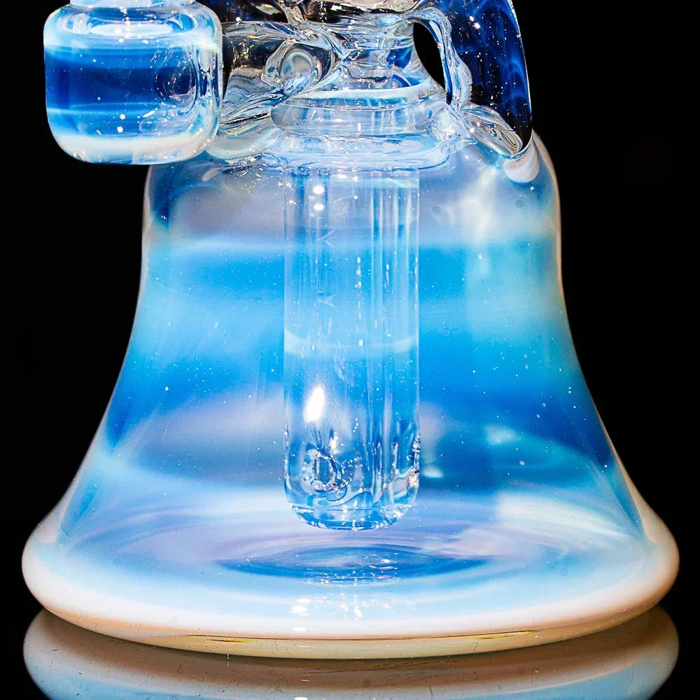 Blue and white glass recycler water pipe with split window detail on black background