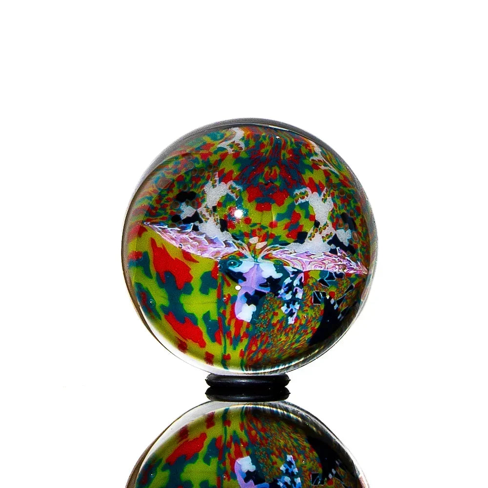 Colorful glass marble with intricate butterfly design and abstract patterns