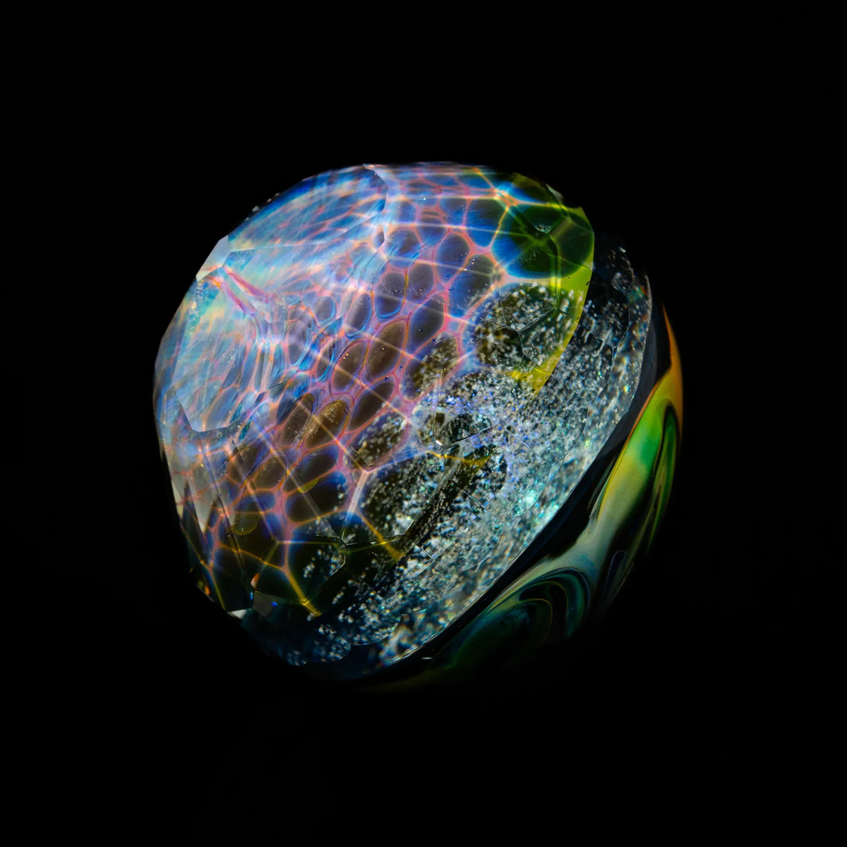 Colorful glass marble with intricate patterns and iridescent details on black background