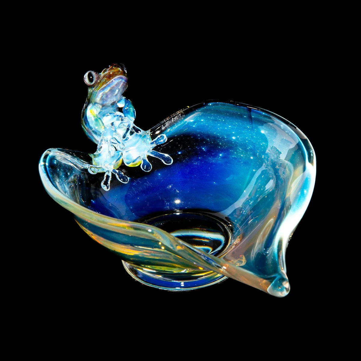 Handcrafted glass trinket dish with a colorful frog sculpture on the rim, blue galaxy swirl design.