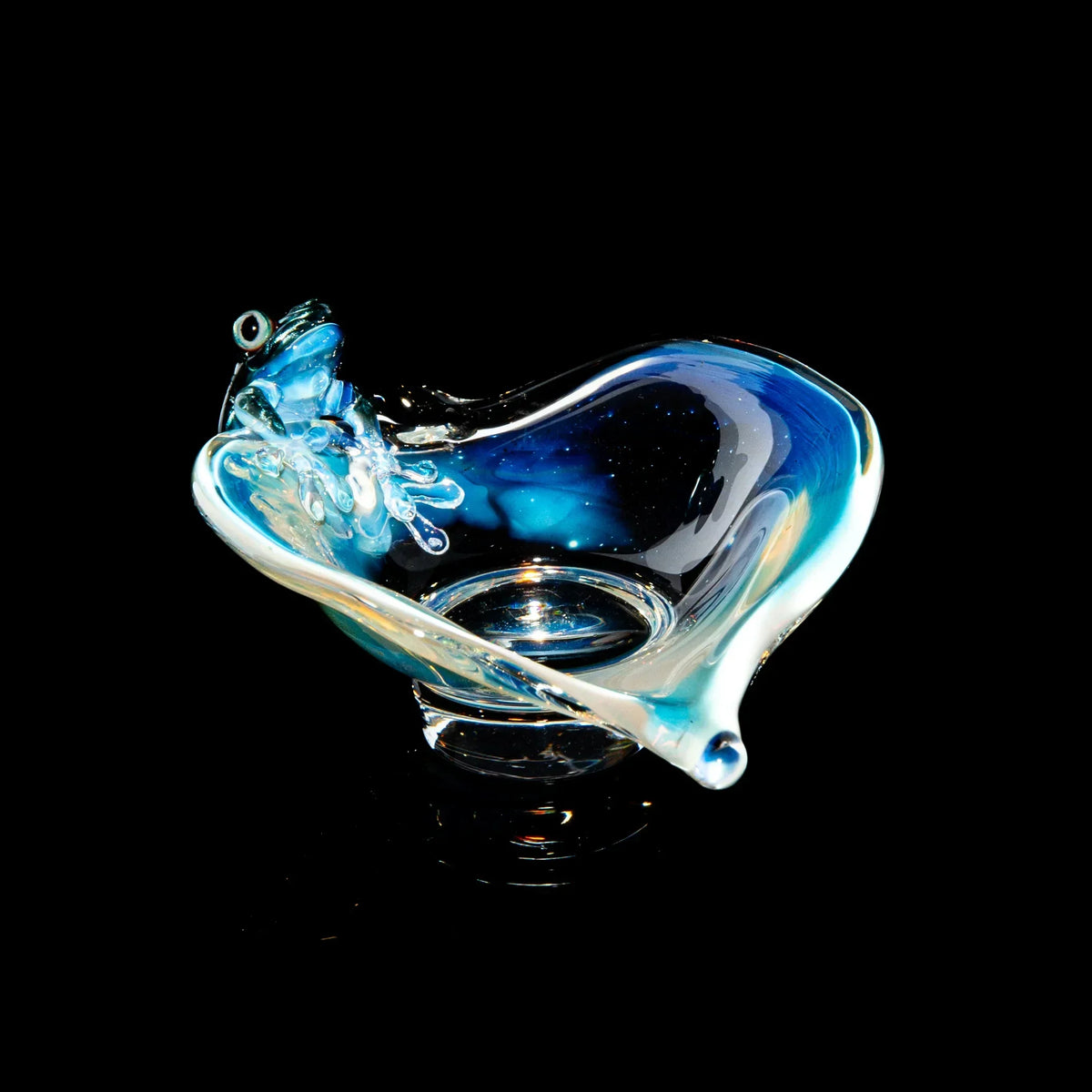 Handcrafted glass trinket dish with a blue frog design on black background