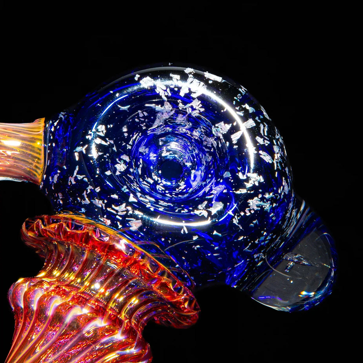 Large blue glass spoon pipe with fume accents and silver flake details on black background