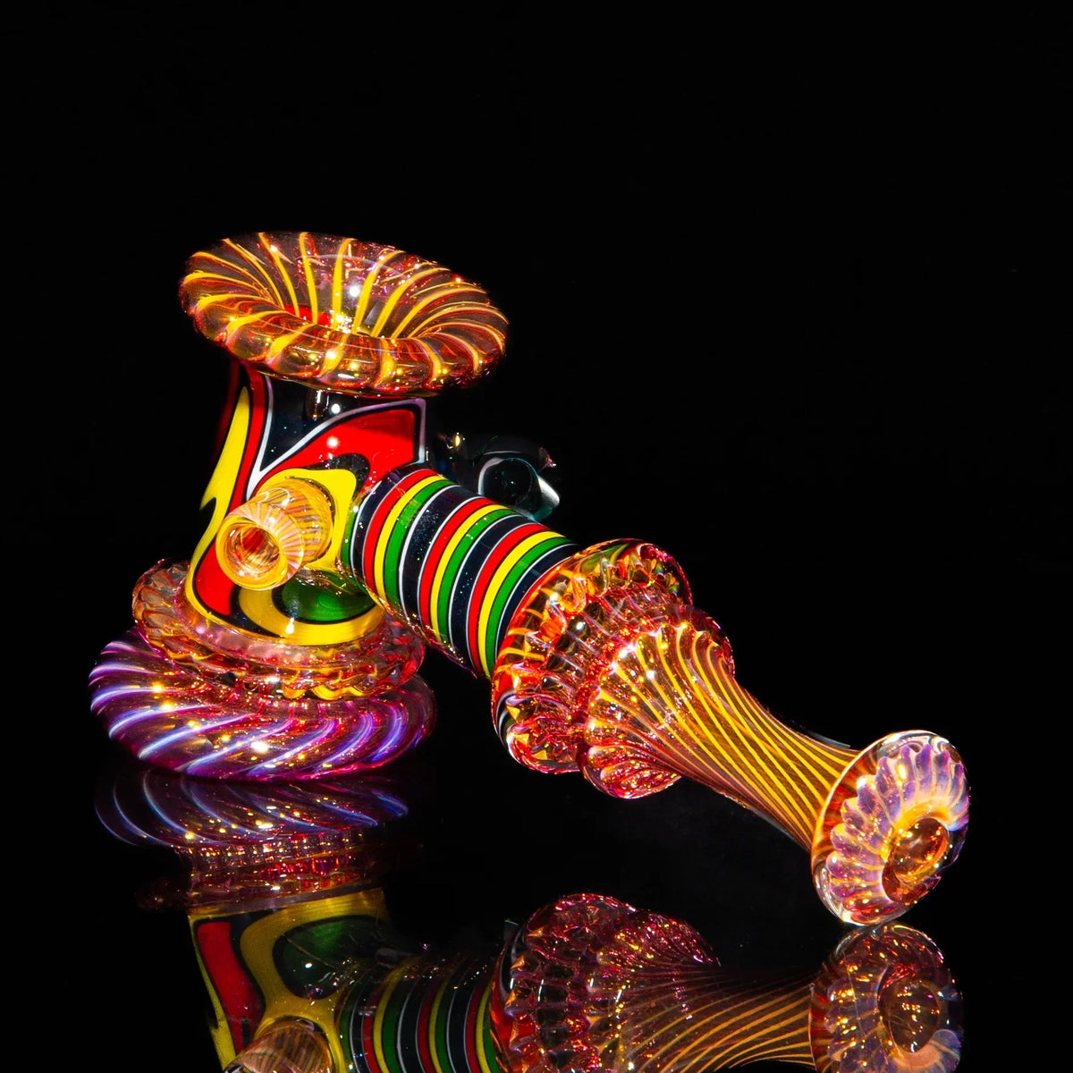 Heady glass hammer pipe with colorful rasta linework and fume design on black background