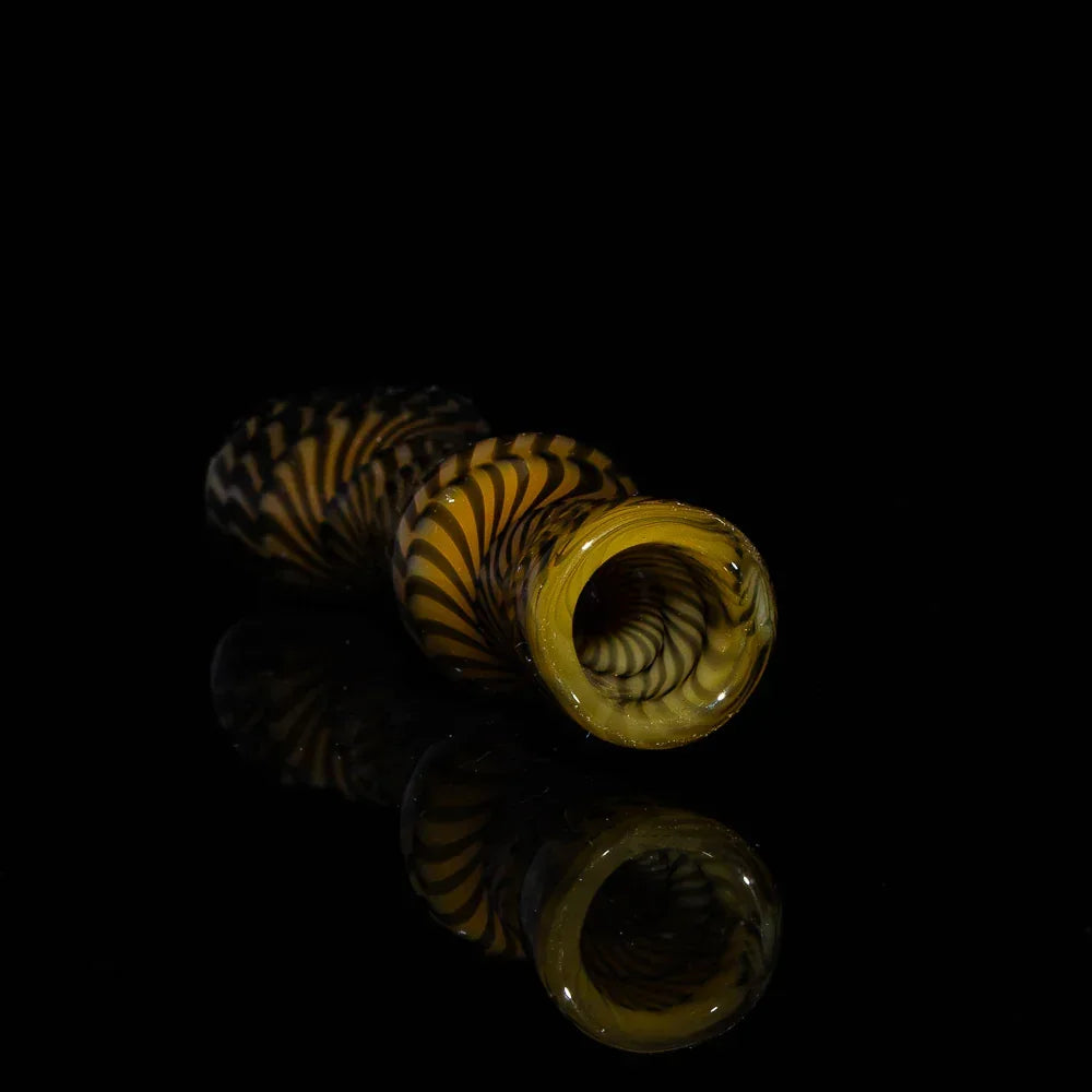 Brown and black glass chillum pipe with spiral coil design on a black background