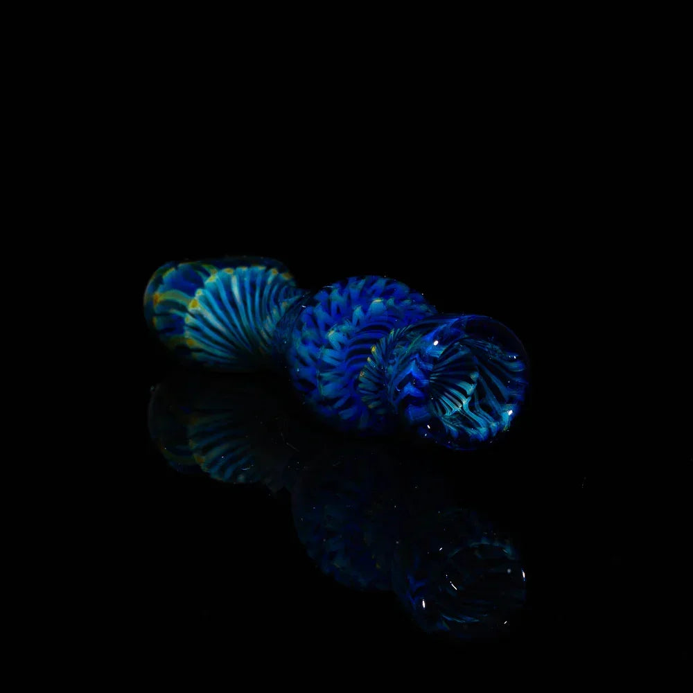 Handcrafted dark blue glass chillum with intricate coil pattern on black background