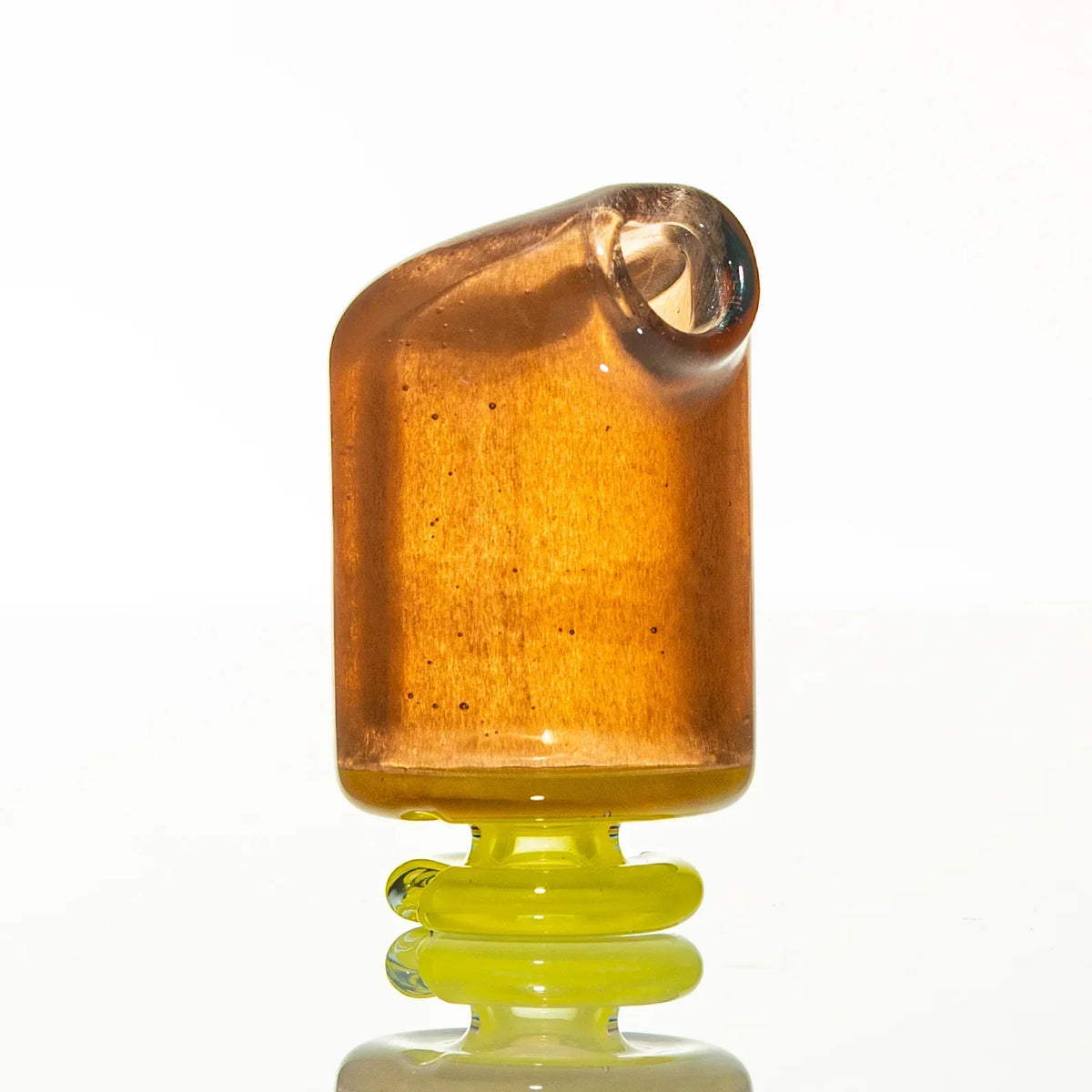 Amber glass mouthpiece with yellow base, modern smoke accessory on white background