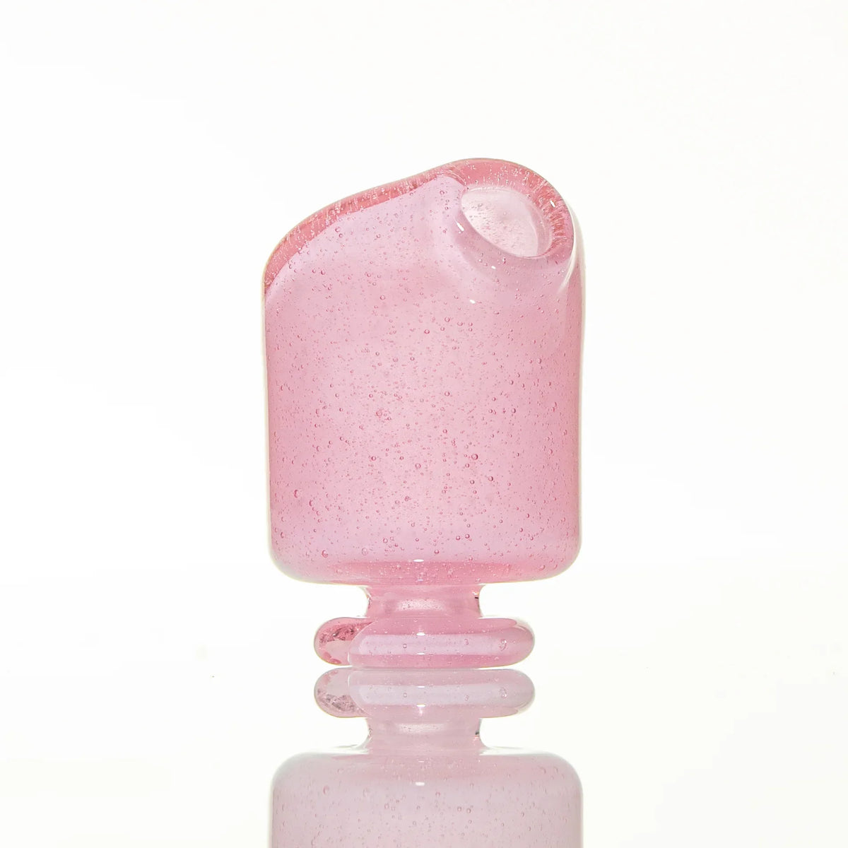 Handcrafted pink glass mouthpiece with clear accents, isolated on white background
