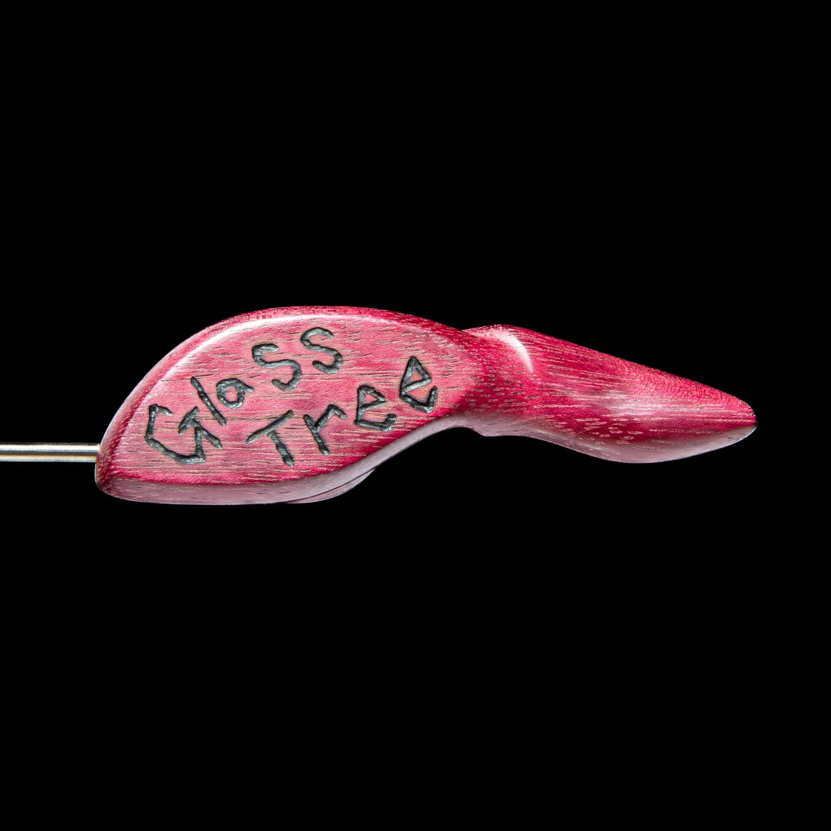 Red wooden dab tool handle with 'Glass Tree' engraved, isolated on black background