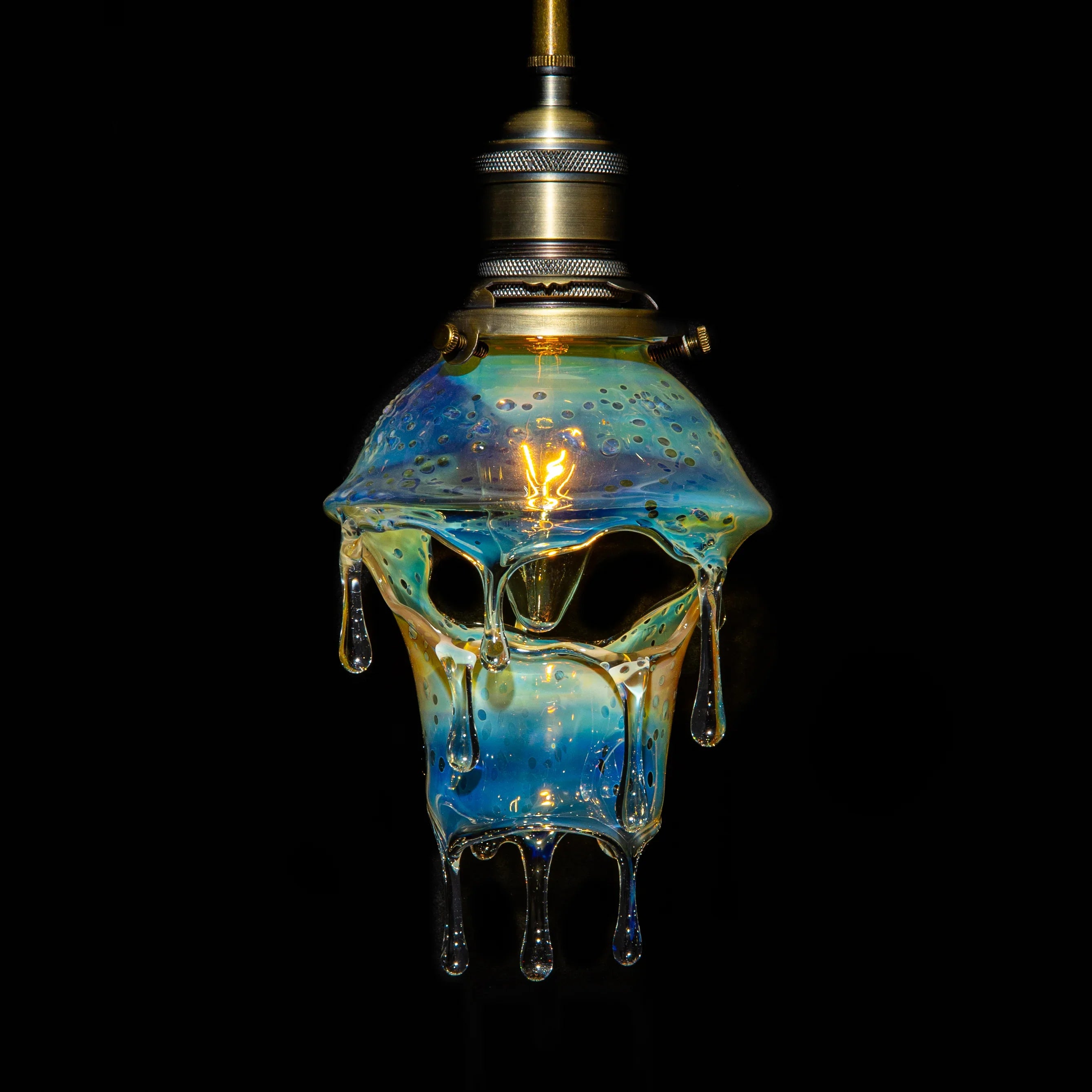 Dripping glass art lamp with blue and yellow hues, unique pendant light on black background