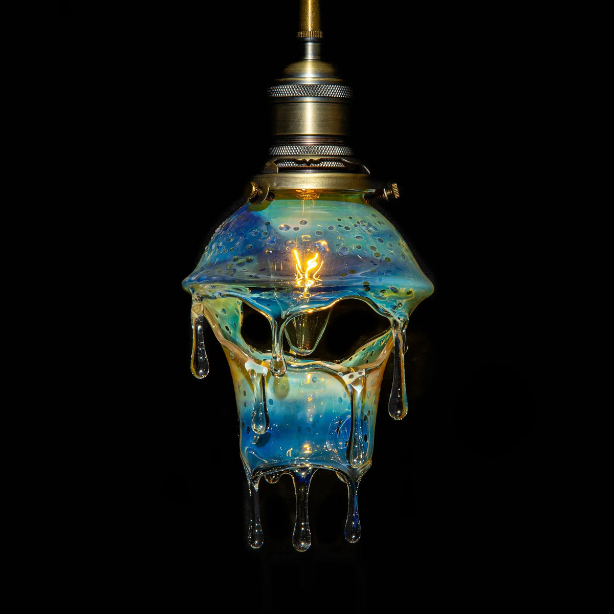 Dripping glass art lamp with blue and yellow hues, unique pendant light on black background