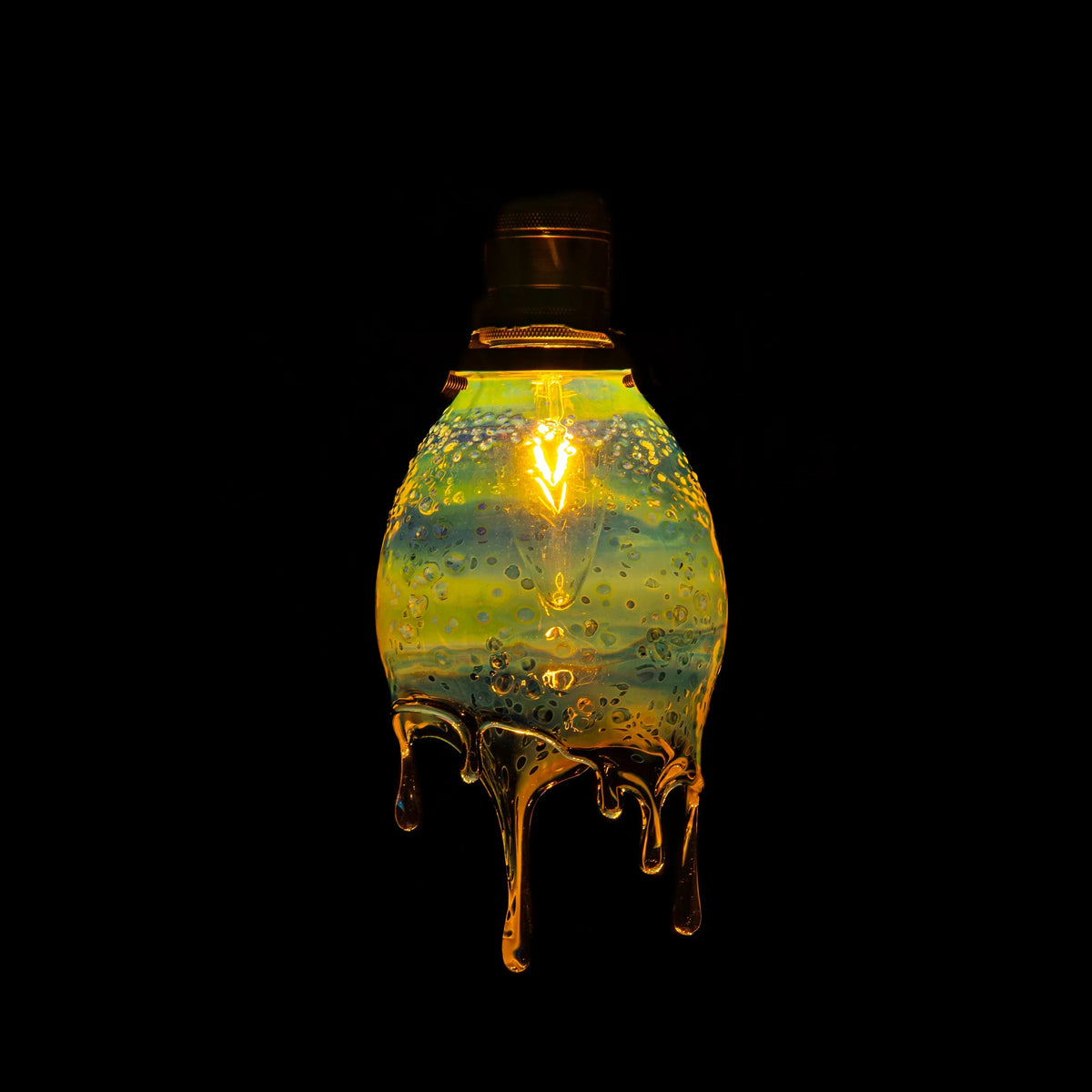Handcrafted glass drip lamp with glowing yellow light and artistic bubble details