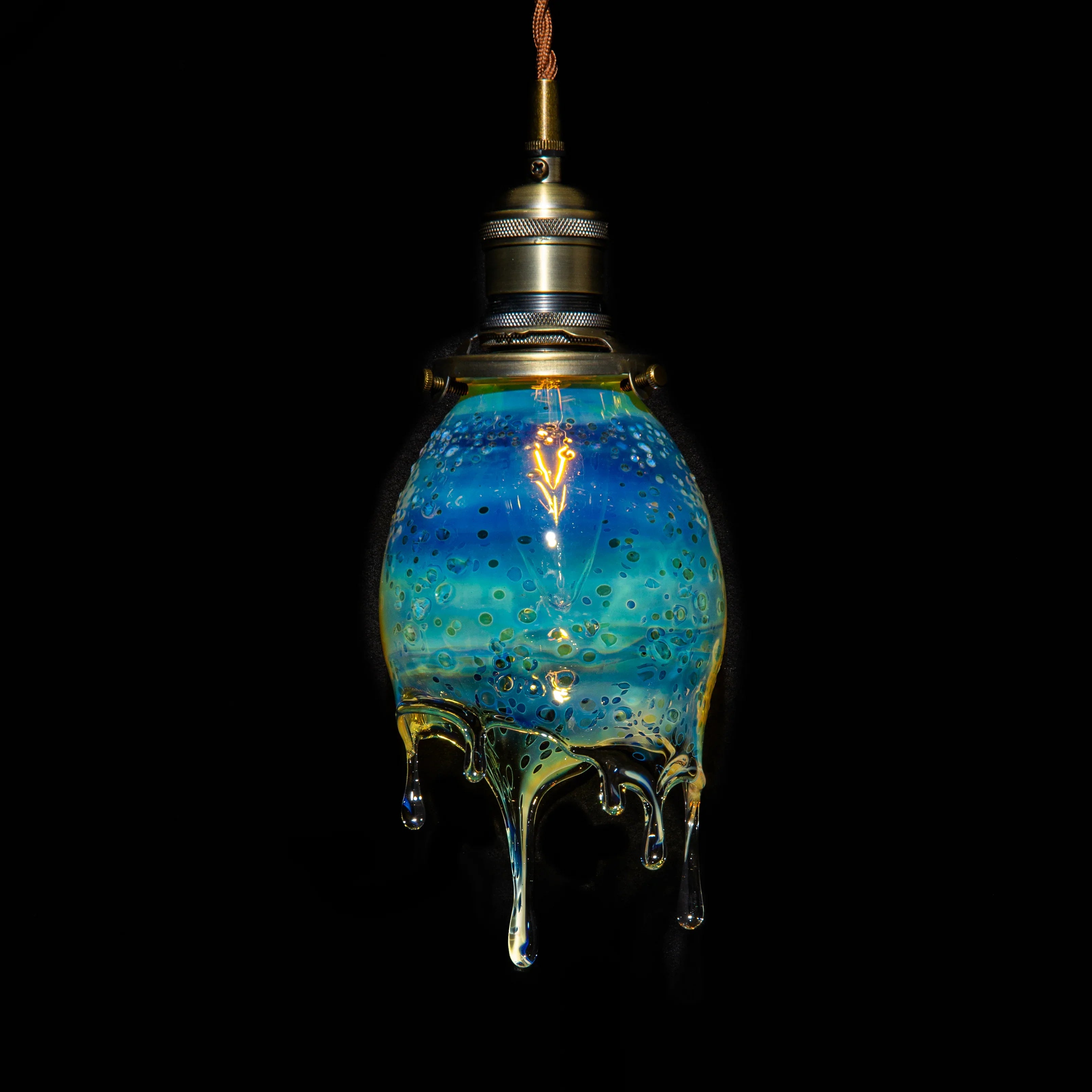 Handblown blue glass pendant lamp with dripped, textured design and brass fixture