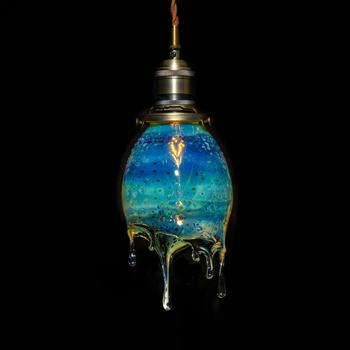 Handblown blue glass pendant lamp with dripped, textured design and brass fixture