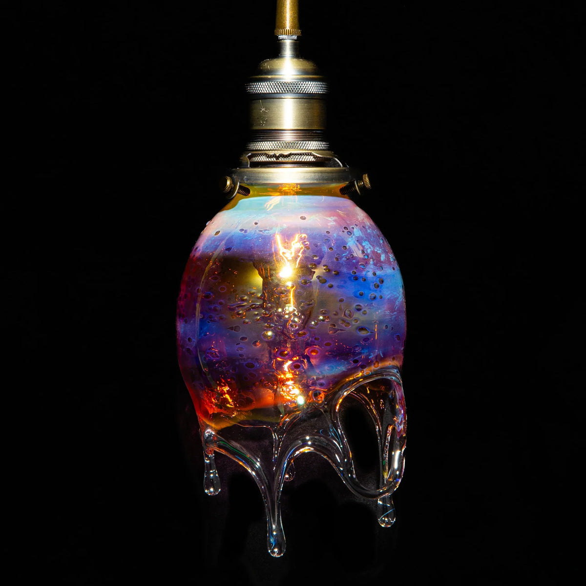 Colorful blown glass pendant lamp with drip design and iridescent hues on black background