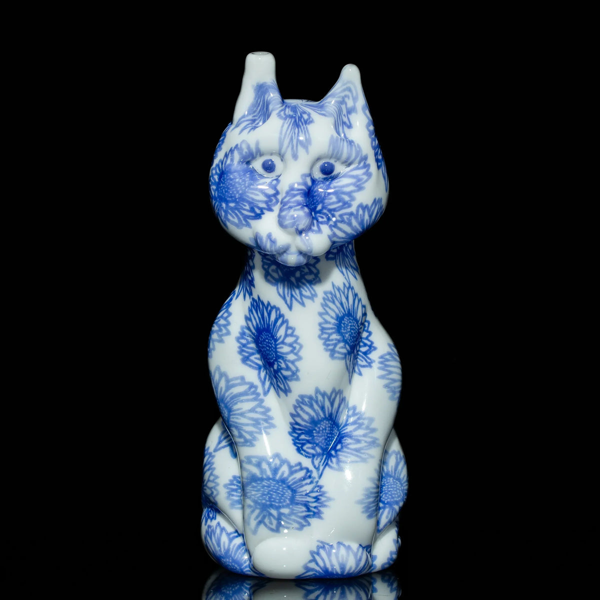 Blue and white glass cat pipe with sunflower pattern on black background